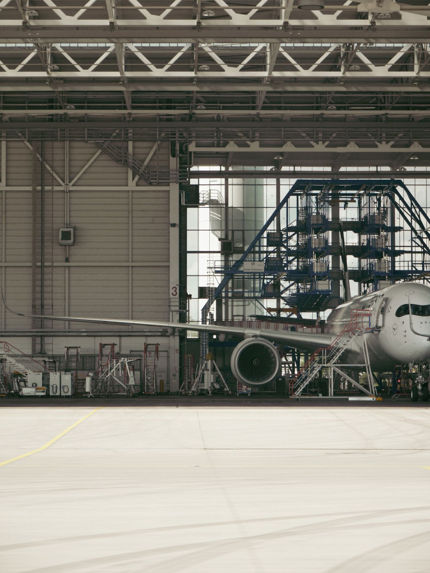 Commercial aircraft undergoing maintenance in a hangar